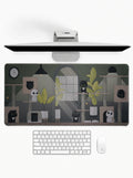 Cozy Cat Haven deskmat featuring cute cats, indoor plants, and cozy room artwork with stitched edges