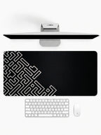 Onyx Maze deskmat featuring geometric maze-inspired artwork with black and white minimalist design