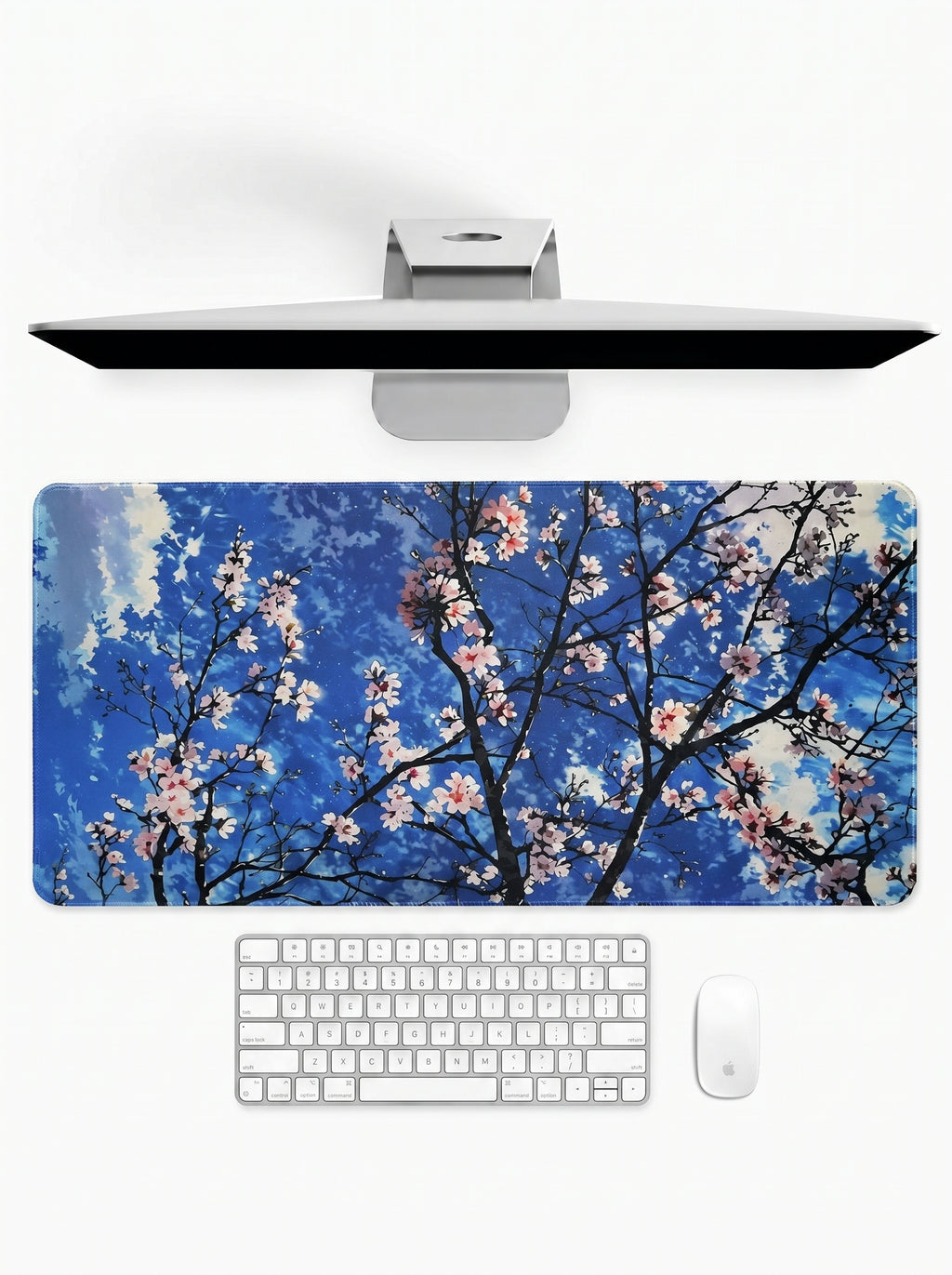 Sakura Sky deskmat featuring cherry blossom branches against a bright blue sky