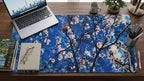 Sakura Sky deskmat featuring cherry blossom branches against a bright blue sky