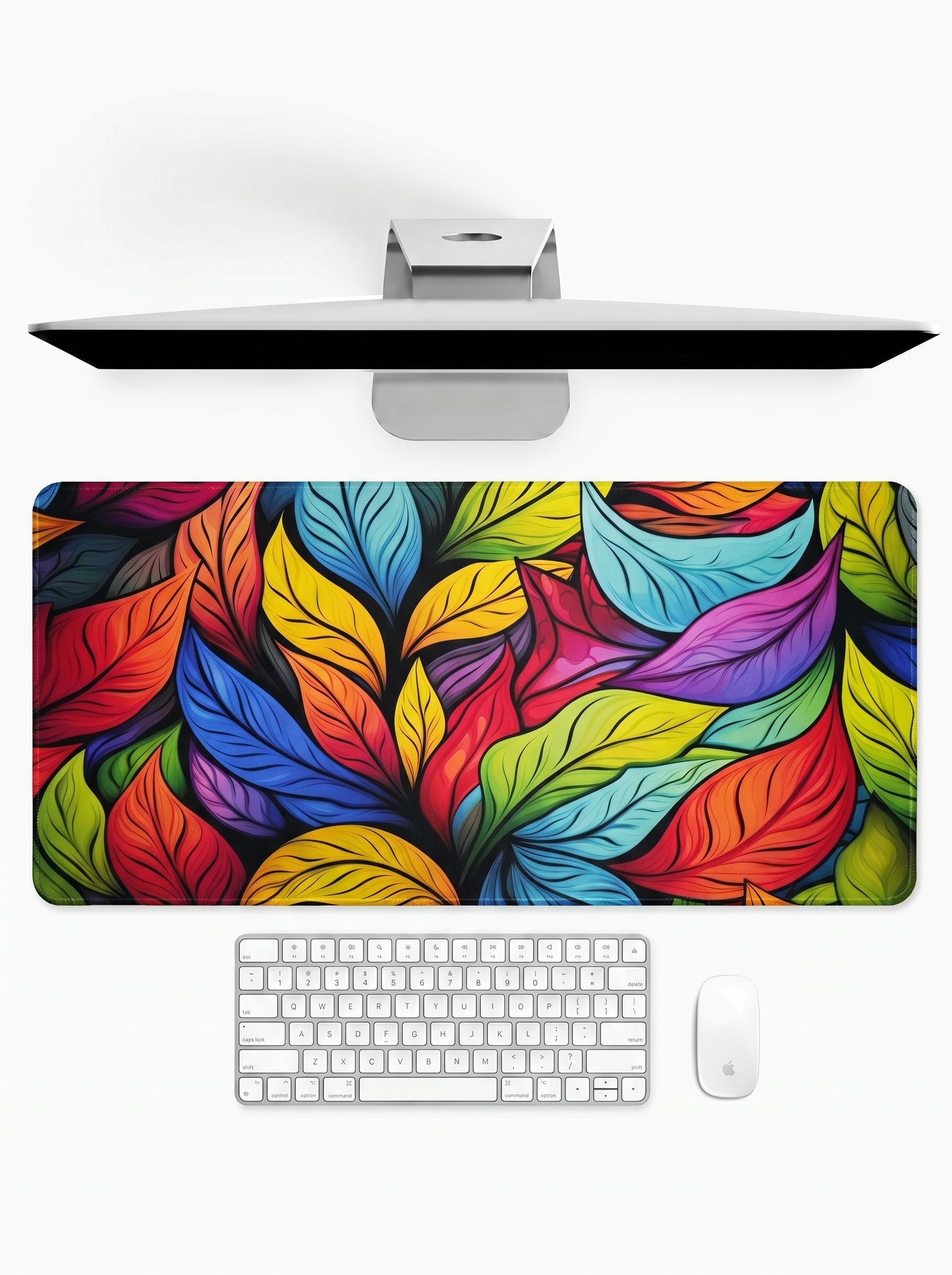 Stained Glass Flora deskmat featuring colorful botanical leaf artwork and stitched edges