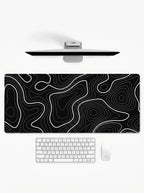 Topography XL deskmat featuring white contour lines on a black background