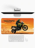 Trailblazer deskmat featuring an adventure motorcycle rider on an off-road journey